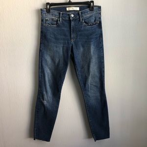 Gap true skinny ankle raw split hem studded jeans.
